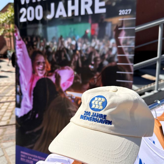 helle Kappe vor einem Banner mit der Aufschrift "Wir feiern 200 Jahre"
