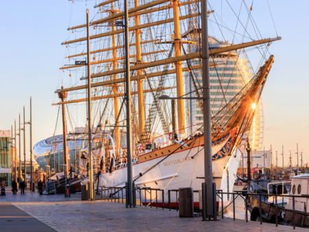 Das historische Segelschiff Schulschiff Deutschland liegt im Sonnenlicht am Kai des Neuen Hafens.