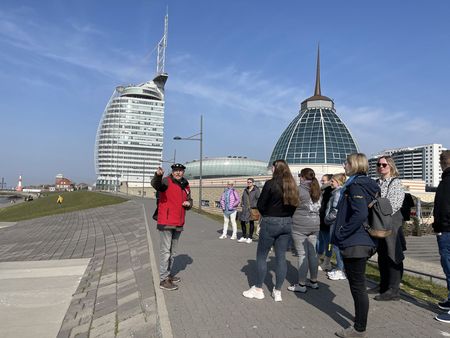 Ein Gästeführer erzählt einer Gruppe etwas über Bremerhaven